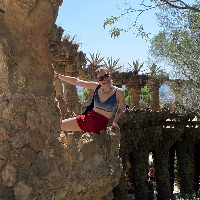 Artist standing next to palm trees in Park Güell, Barcelona