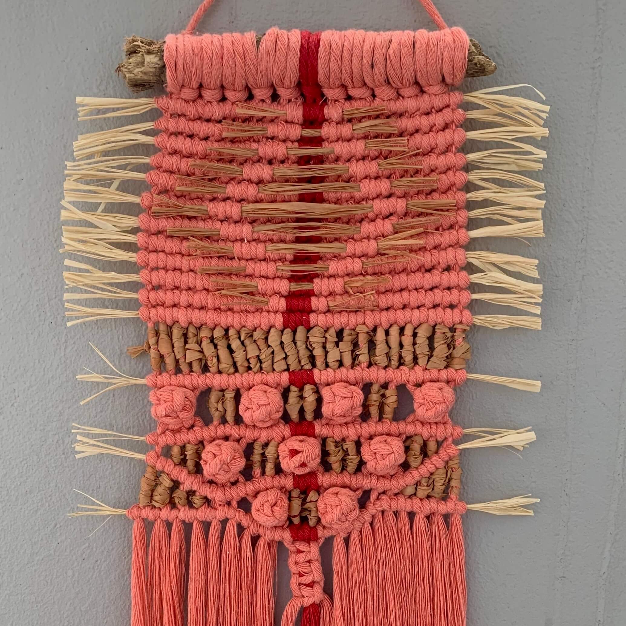 handmade pink macrame wallhanging with raffia details